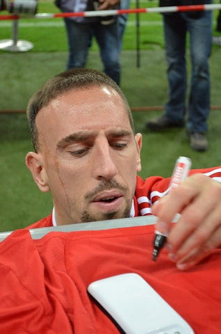 stock image of an athlete signing an autograph for a fan